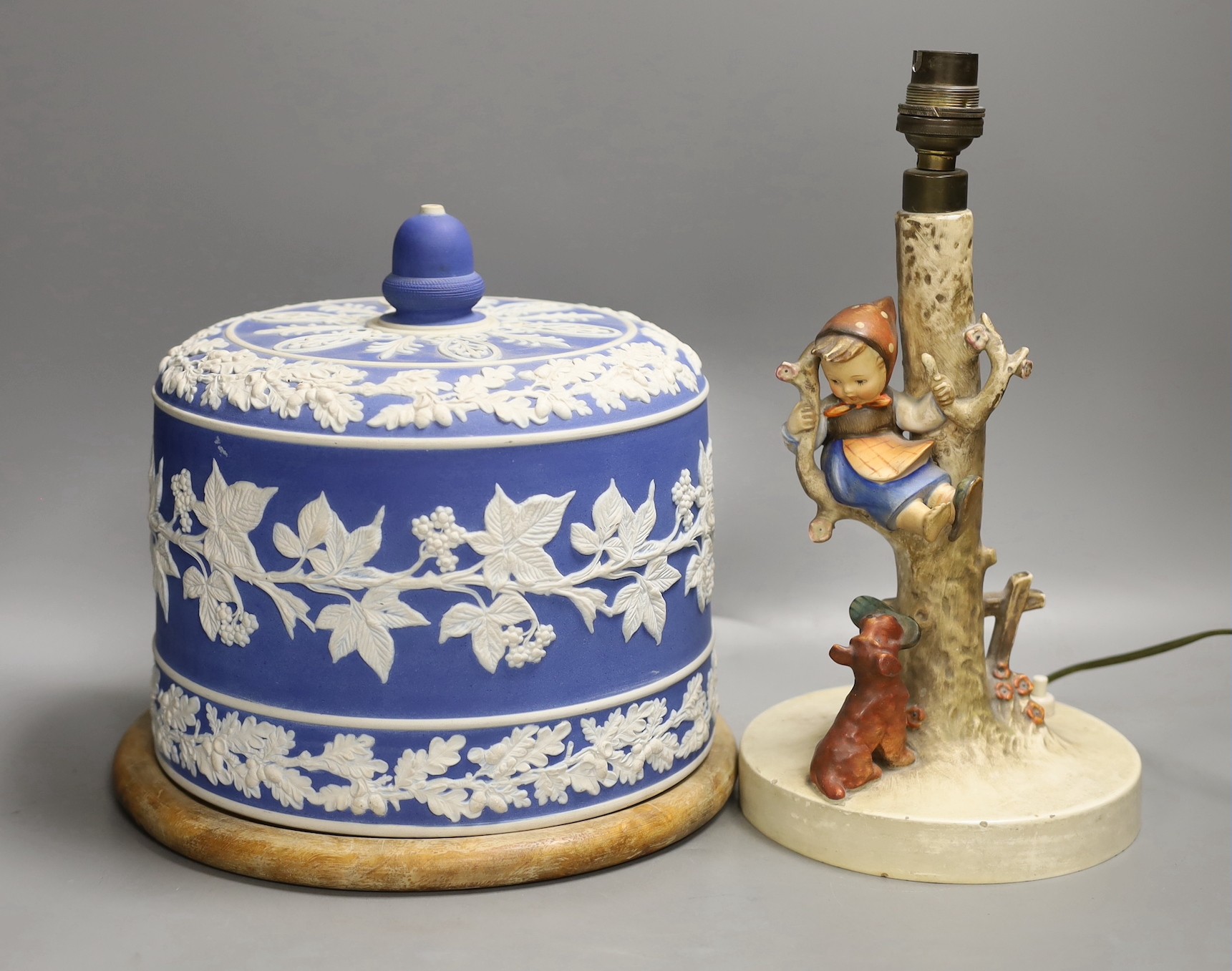A Victorian blue jasper cheese bell cover, later wood stand, 23 cm high, and a Hummel table lamp